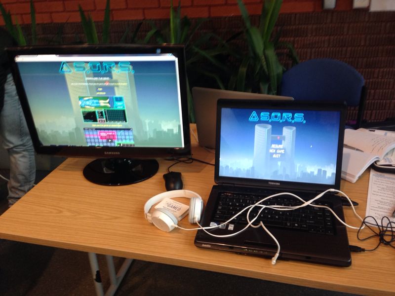 The updated demo ready for play testers, alongside a monitor showing the game website.